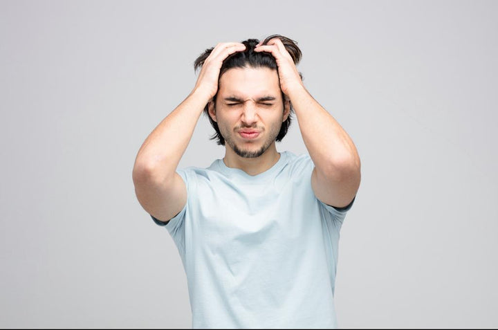 Man keeping his hands on head with eyes closed | How to remove lice from hair permanently