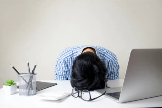 Men resting his head down on table | Instant energy drinks 