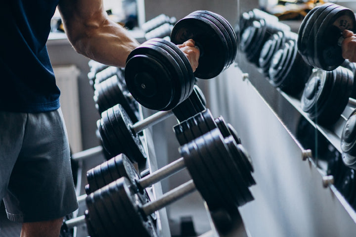 a man lifting dumbbells