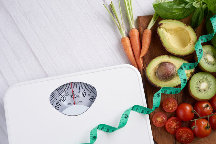 a weight loss machine is kept on a table along with nutritious fruits