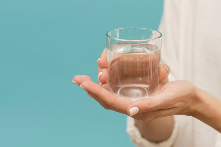 a man holding a glass of water